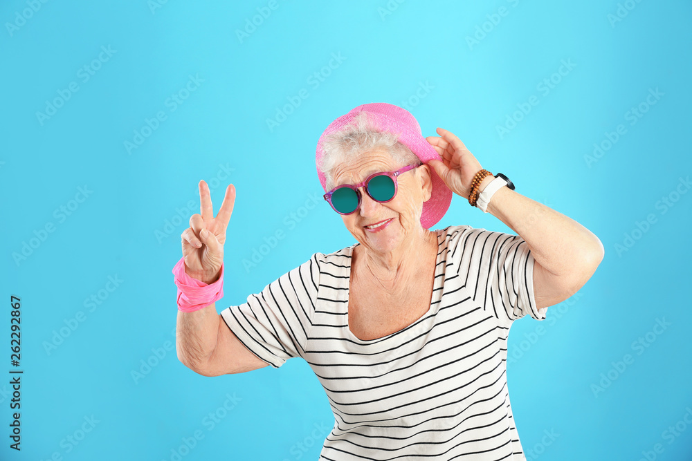 Naklejka premium Portrait of cool grandmother on color background