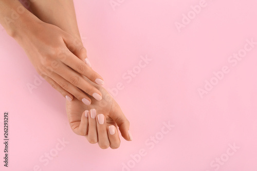 Closeup view of woman with beautiful hands on color background  space for text. Spa treatment