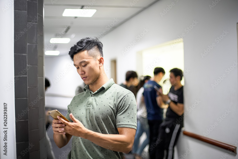 Asian handsome men concentrating on smartphone | typing message on cellphone Asian handsome men concentrating on smartphone | typing message on cellphone