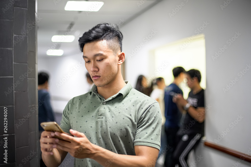 Fototapeta premium Asian handsome men concentrating on smartphone | typing message on cellphone