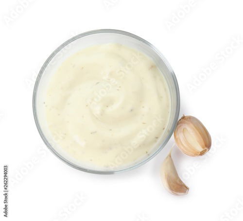 Bowl of homemade sauce and garlic cloves isolated on white, top view