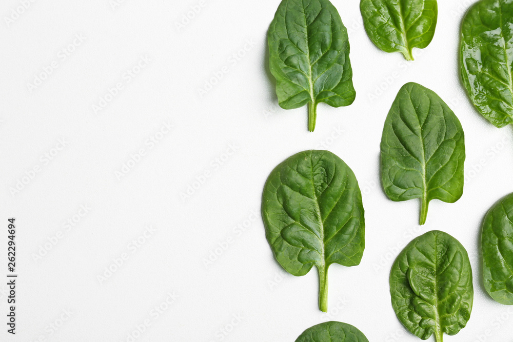Obraz Fresh leaves of spinach isolated on white, top view