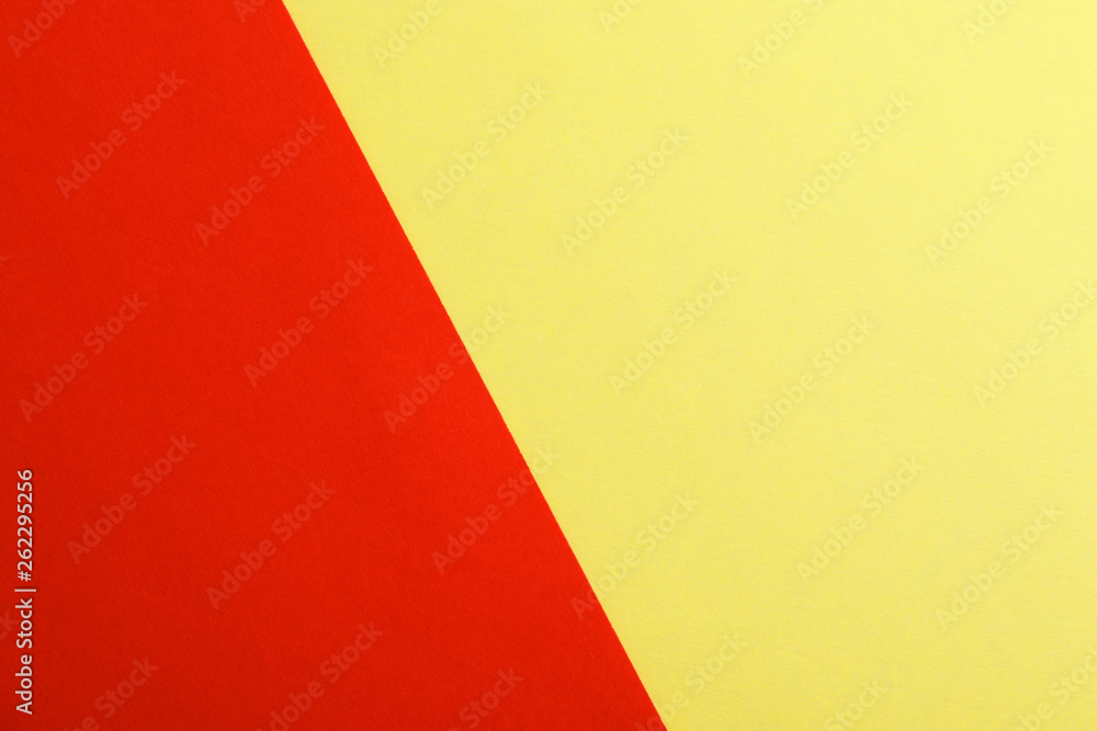 Yellow and red paper sheets as colorful background, top view
