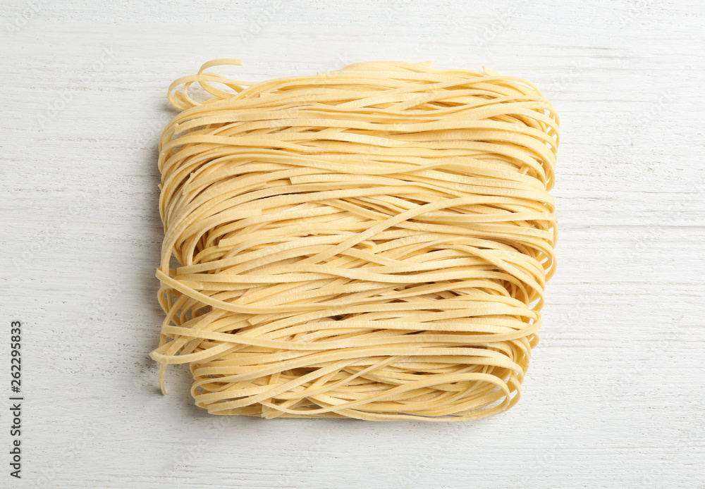 Block of quick cooking noodles on wooden background, top view Block of quick cooking noodles on wooden background, top view