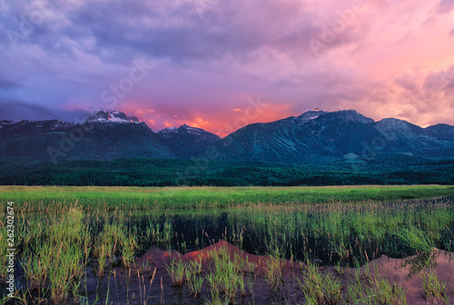 Sunset lights up clouds over Hunters Range of the Monashee Mountains beyond Columbia River, British Columbia, Canada