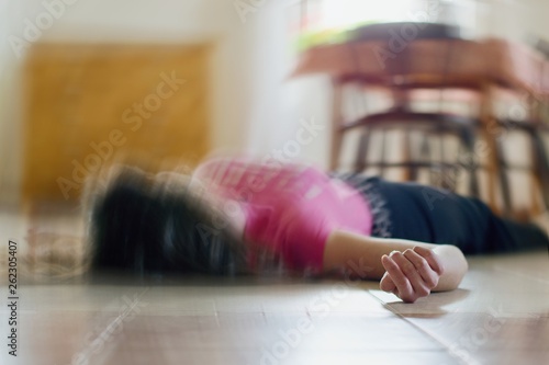 Woman lying on the floor at home, epilepsy, unconsciousness, faint, stroke, accident or other health problem. photo