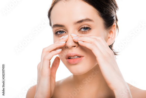 beautiful nude woman touching nose after rhinoplasty and looking at camera isolated on white photo