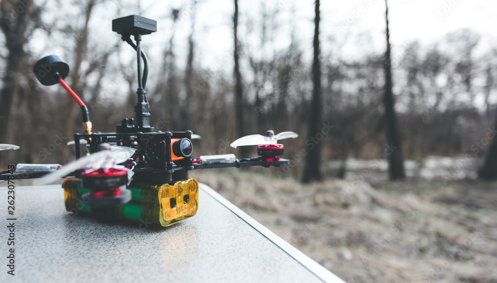 A small self made FPV drone lies on the table before the flight. A small self made FPV drone lies on the table before the flight.
