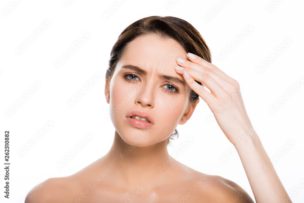 sad naked woman touching face and looking at camera isolated on white