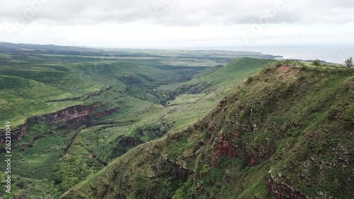 Wide panoramic of green cliff and ocean in Hawaii