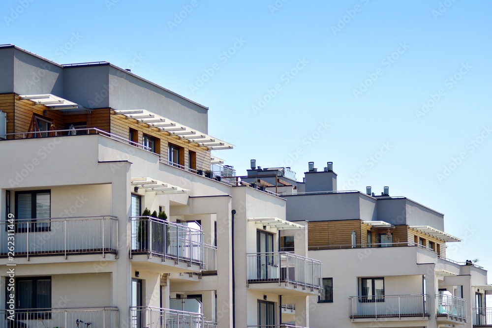Fototapeta premium Modern apartment buildings on a sunny day with a blue sky. Facade of a modern apartment building