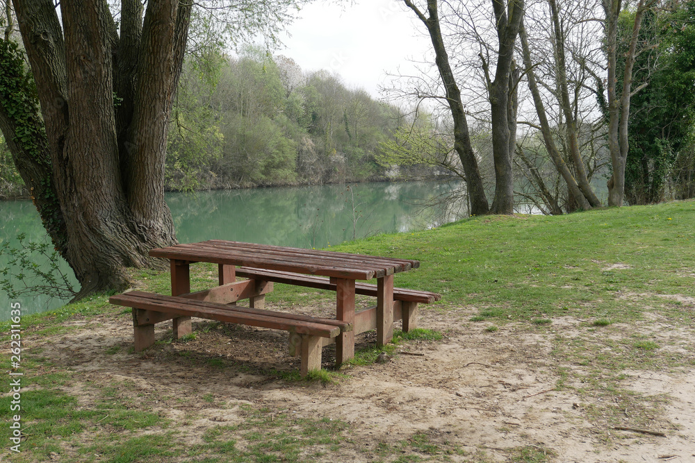 Benches and table near a river Benches and table near a river