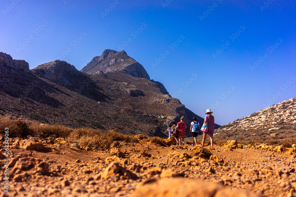 Tourists descend from the mountains to the beach of Balos in Crete, Greece Tourists descend from the mountains to the beach of Balos in Crete, Greece
