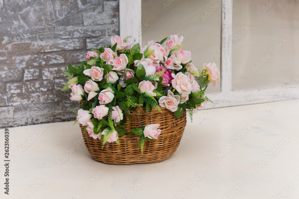 Artificial flowers in a basket