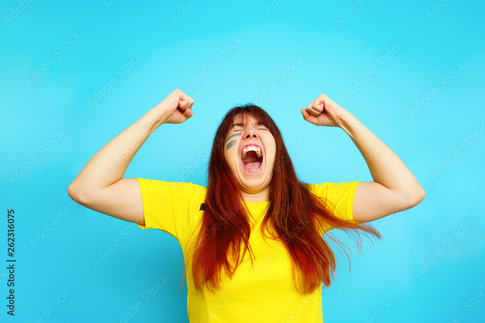 Woman is socccer fan in yellow t-shirt Woman is socccer fan in yellow t-shirt