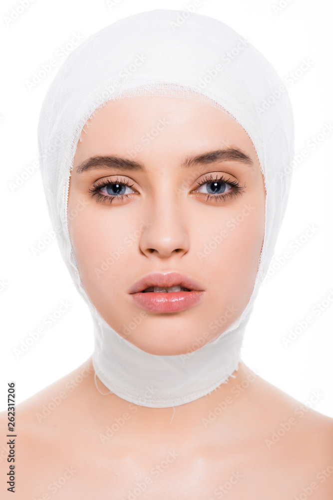 attractive young woman with bandaged head looking at camera isolated on white attractive young woman with bandaged head looking at camera isolated on white