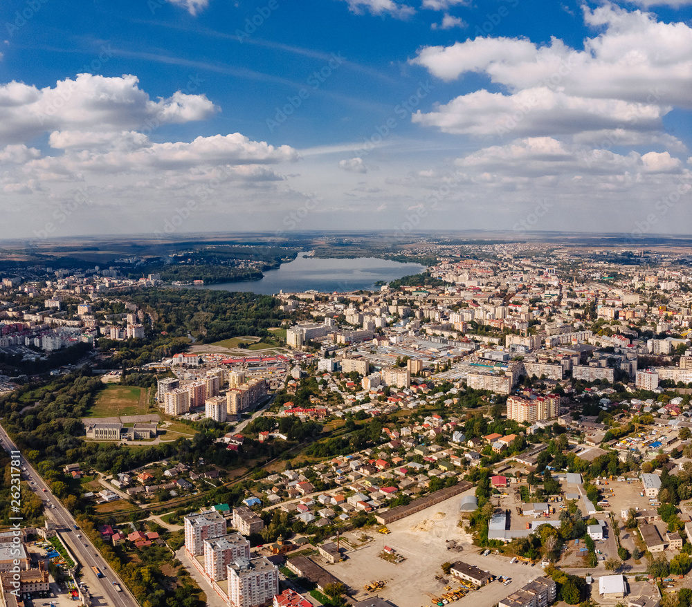 landscape view over city on summer sunny day with clouds aerial and view to lake
