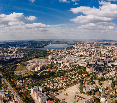 landscape view over city on summer sunny day with clouds aerial and view to lake