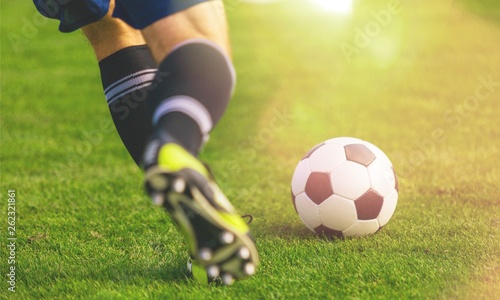 Running soccer player on grass photo