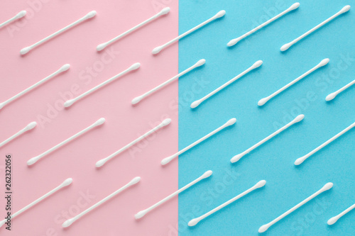 white cotton swabs on pink and blue background