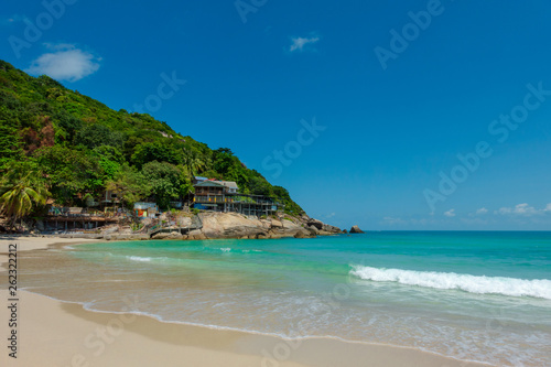 White sandy tropical beach with calm wave and blue lagoon on sunny day © Sloniki