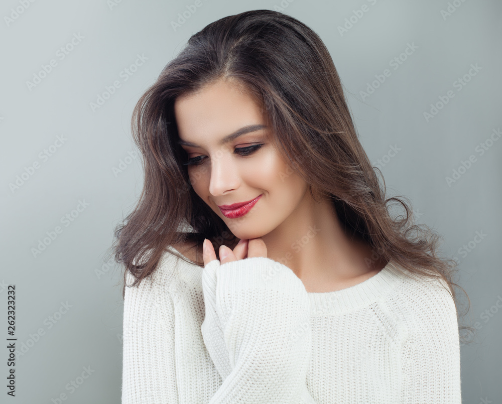 Smiling woman portrait. Pretty model girl on gray background Smiling woman portrait. Pretty model girl on gray background