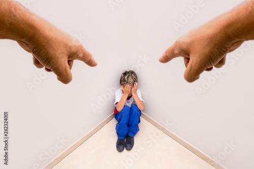Canvas Print Boy alone being accused by an adult hand
