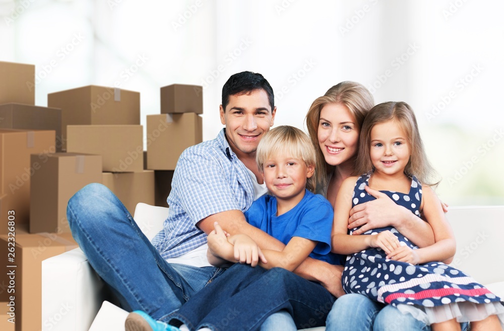 Beautiful smiling family sitting at sofa at home Beautiful smiling family sitting at sofa at home