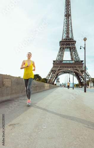 fit woman in fitness clothes in Paris, France jogging