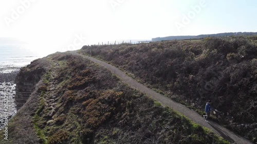 man walking down cliff path coastal 4k summer's day stunning