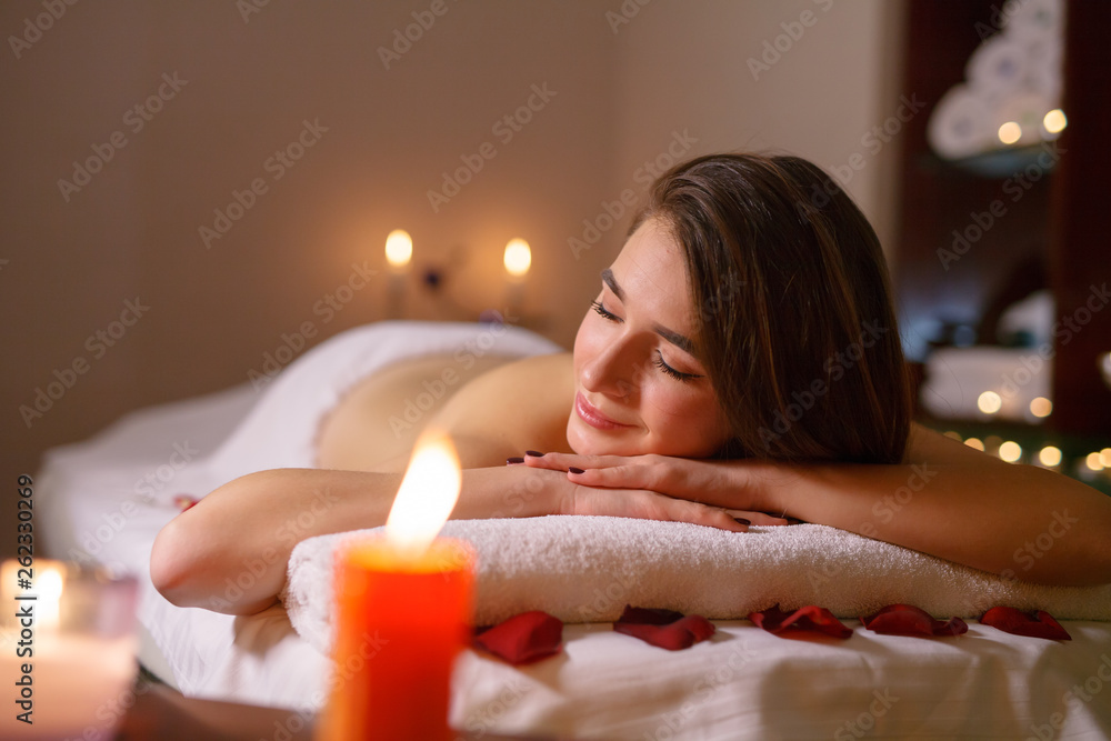 Naklejka premium Girl on massage in the spa salon