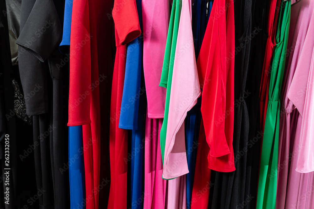 Cocktail dress. Clothing on hanger at the modern shop boutique. Bright multi-colored fabrics. concept of shopping. Cocktail dress. Clothing on hanger at the modern shop boutique. Bright multi-colored fabrics. concept of shopping.