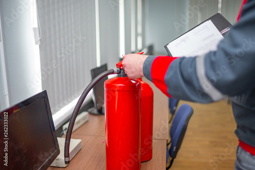 Engineer Professional are Checking A Fire Extinguisher Using Clipboard or checking Industrial fire control system,Fire Alarm controller, Fire notifier, Anti fire.System ready In the event of a fire.