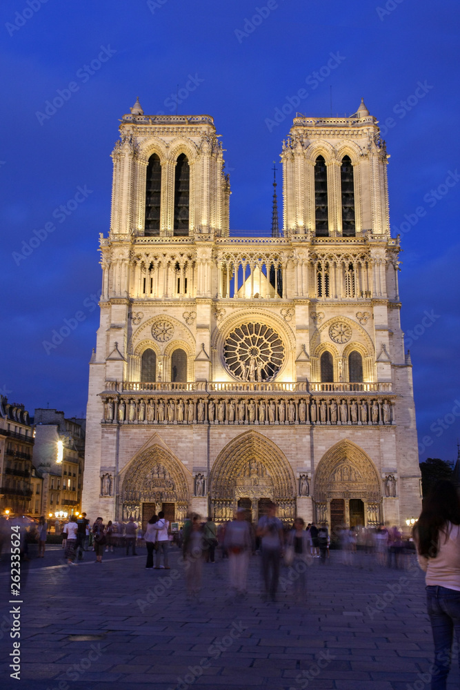 Notre Dame cathedral front in the early evening blue hours, Paris, France