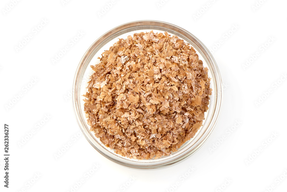 Wheat bran in a glass bowl, organic food, top view, isolated on white background Wheat bran in a glass bowl, organic food, top view, isolated on white background