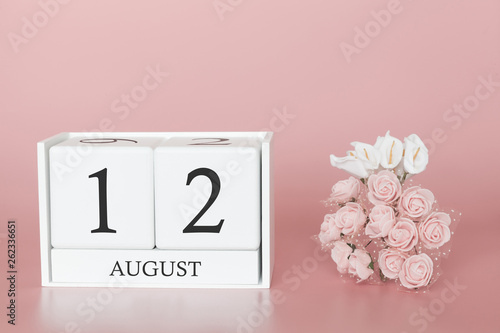 August 12th. Day 12 of month. Calendar cube on modern pink background, concept of bussines and an importent event. photo