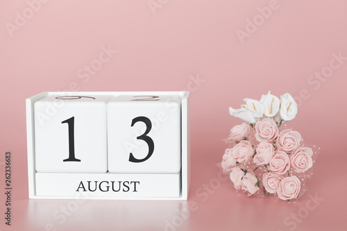 August 13th. Day 13 of month. Calendar cube on modern pink background, concept of bussines and an importent event. photo