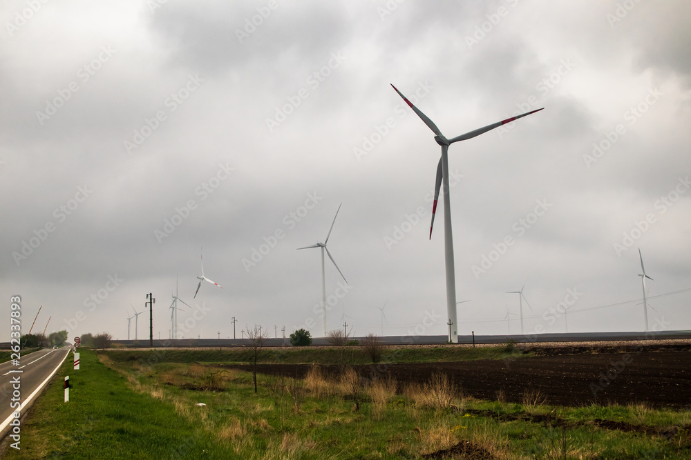 Wind generator turbine or windmill or wind farm, cloudy foggy day Wind generator turbine or windmill or wind farm, cloudy foggy day