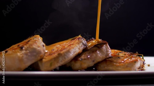 Tasty Pork Steaks. Pouring with Roasted Sauce