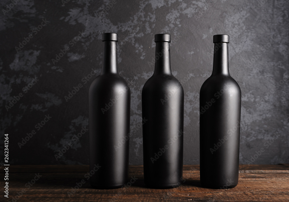 Red wine bottle on a wooden background