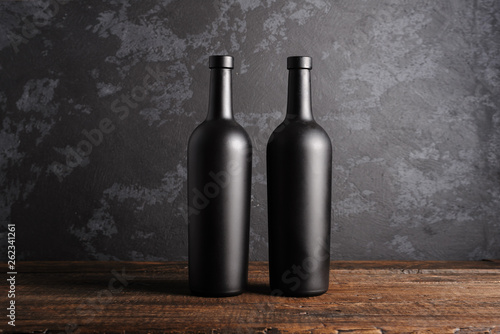 Red wine bottle on a wooden background