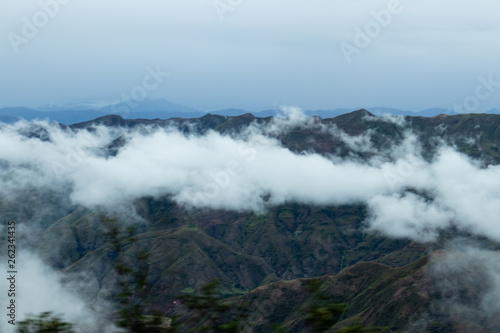 Landscape in Bolivia formed by mountains and white clouds
