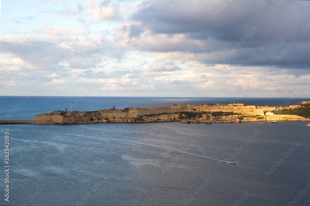 Beautiful sunset in Valletta, Mediterranean sea and old fortress walls, aerial view. 