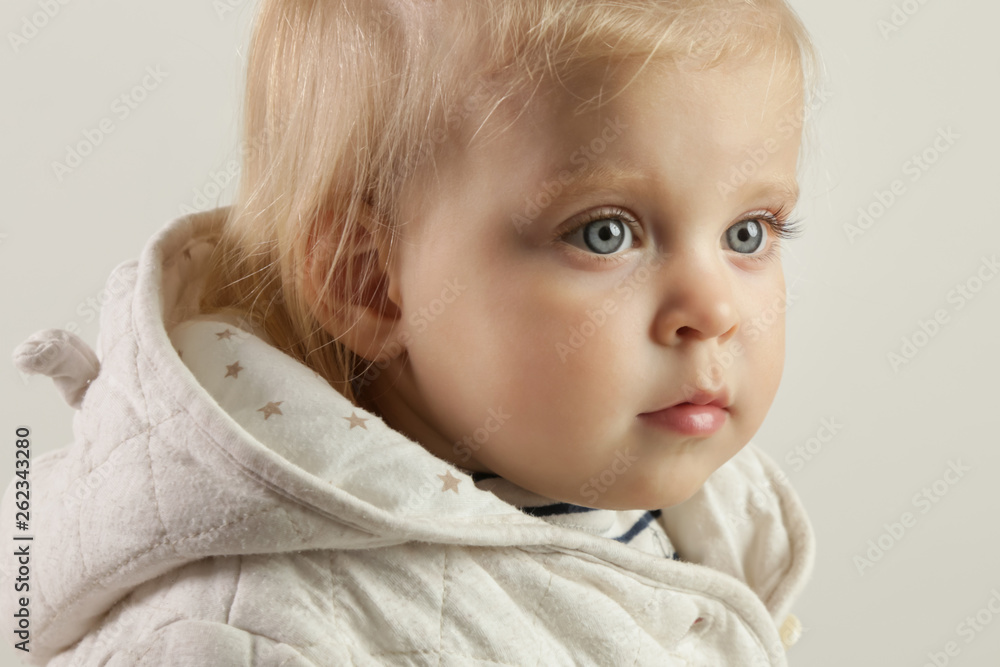 Close up studio portrait of an adorable blonde baby girl with blue eyes Close up studio portrait of an adorable blonde baby girl with blue eyes