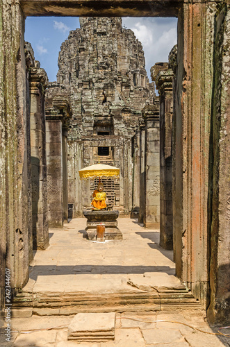 Passageway in Angkor Wat with a small Buddhist shrine photo