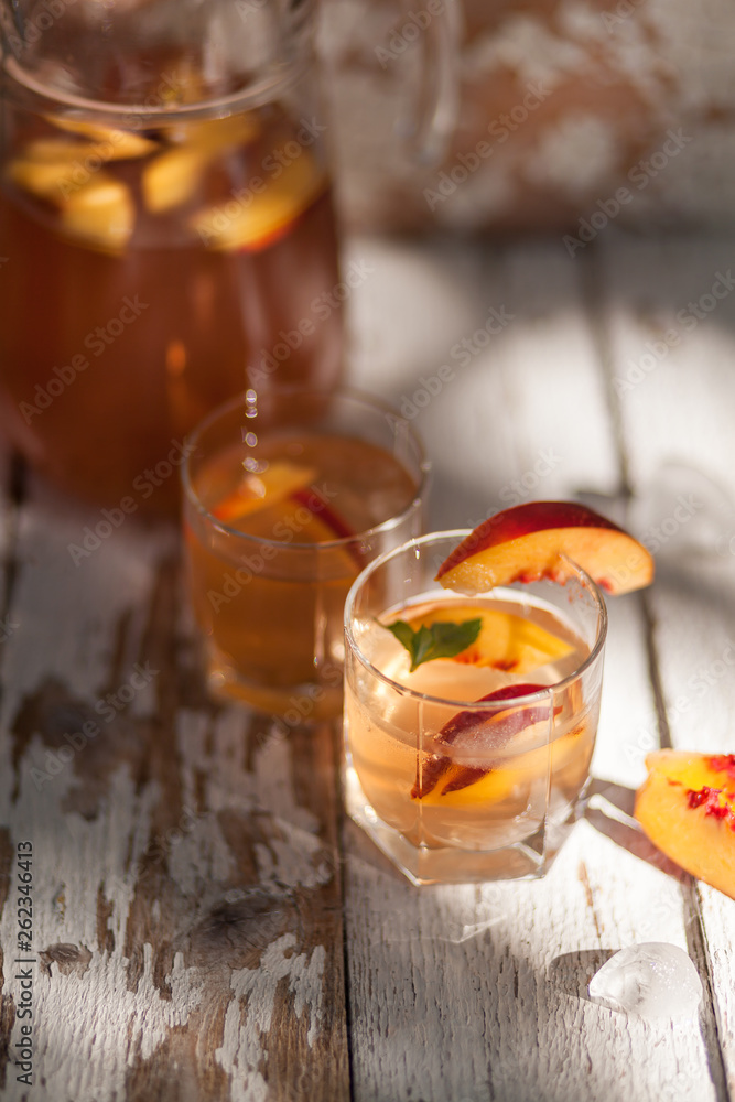 Ice tea and nectarine. Jag, two glasses. A refreshing summer drink Ice tea and nectarine. Jag, two glasses. A refreshing summer drink