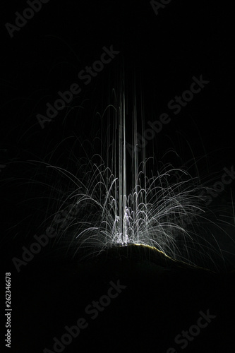 Traces of light in illuminated  waterdrops on cave calcite