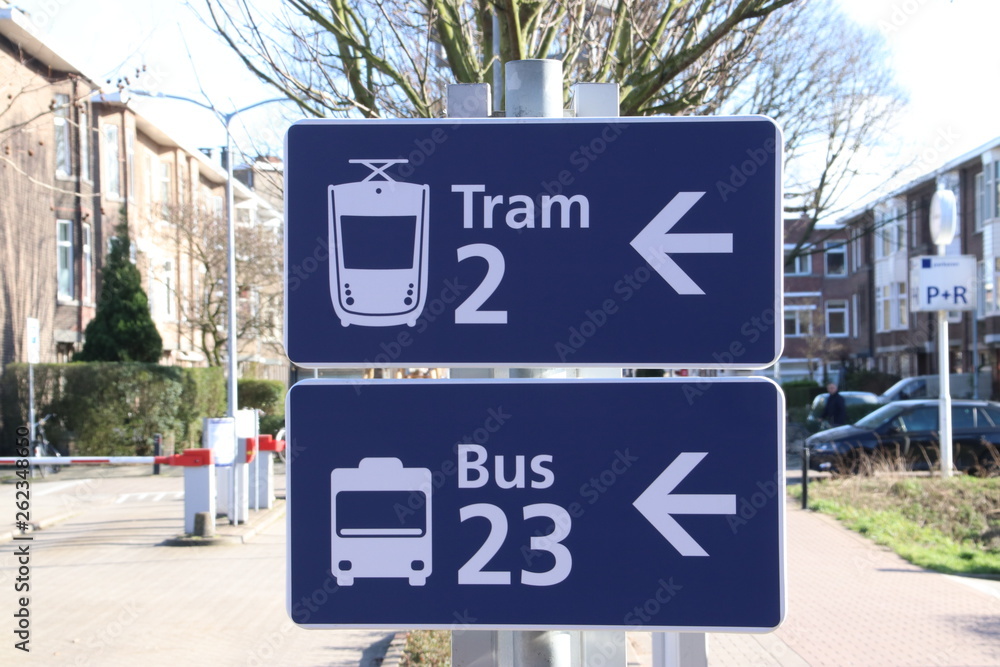 Blue and white sign with direction to the tram and bus at station Laan van NOI in Den Haag