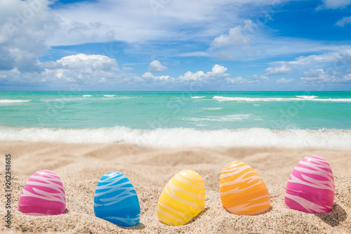 Photography Happy easter lettering background with eggs on the sandy beach