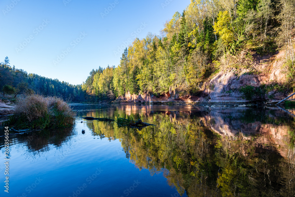 beautiful golden sunrise over forest river with sandstone cliffs on the shores beautiful golden sunrise over forest river with sandstone cliffs on the shores